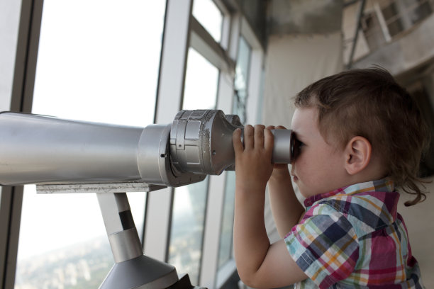 小男孩拿着望远镜