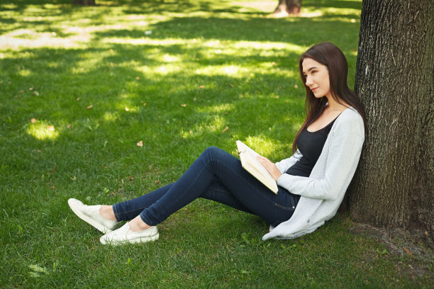 女人盘腿坐着看书
