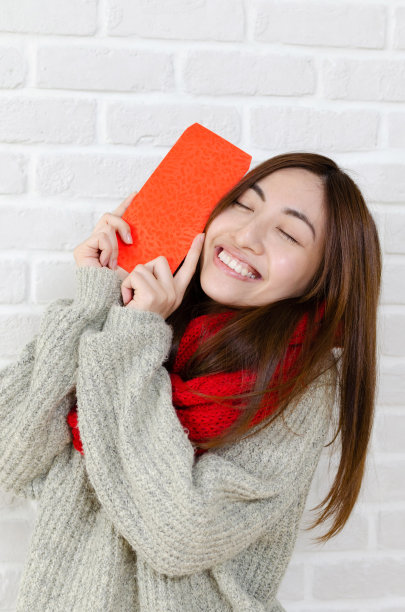 年轻的亚洲女子持有中国新年礼盒