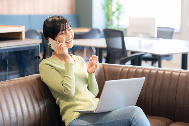 黑发女人用笔记本电脑和智能手机