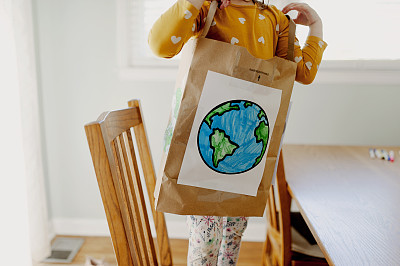 小女孩穿着纸袋地球日服装