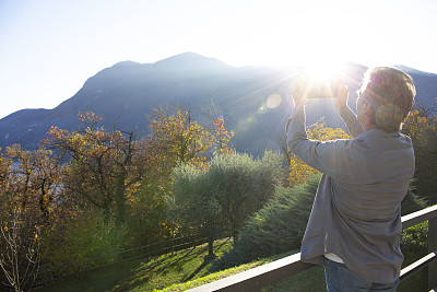 Man relaxes on sunny patio at sunrise