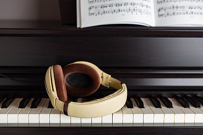 电子钢琴(clavinova)键，耳机和乐谱的特写