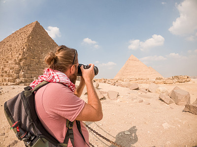 一名男性游客在埃及拍摄金字塔