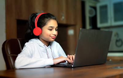 亚洲/印度少女在家里学习家庭作业在线课程，社会远程在线教育的想法概念