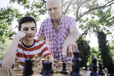 爷爷和孙子在一起下棋。