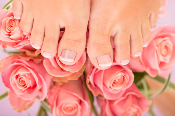 女人在粉红色玫瑰花上修脚后的脚