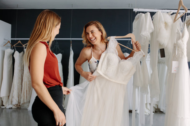 商店助理帮助新娘选择完美的服装