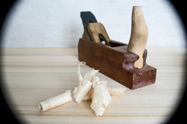 手工制作的木刨子和木屑放在桌子上特写。DIY的概念。木工和工艺品的工具。