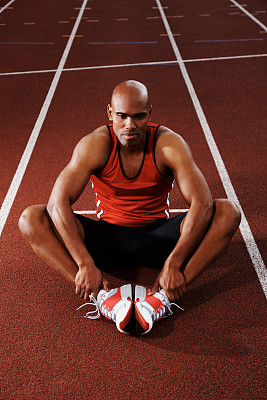 热身——男运动员坐在跑道上