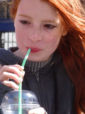想象一个女孩用吸管喝不健康的含糖软饮料