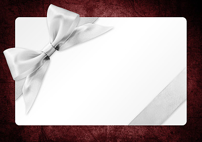 礼品卡与银丝带蝴蝶结孤立在红色背景