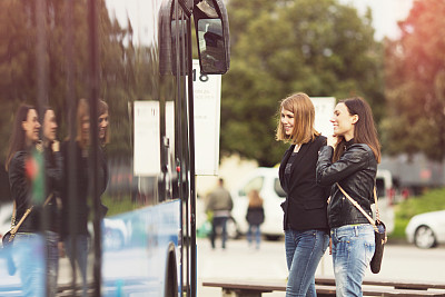 Young women waiting on the bus station