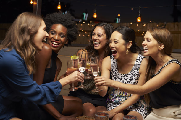 微笑的女人和朋友们在喝酒