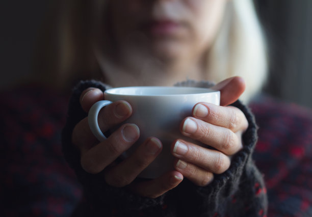 女人手持一杯咖啡