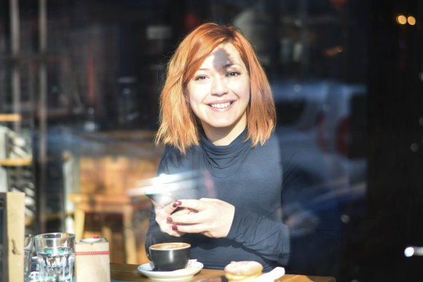 微笑着喝着咖啡的女人