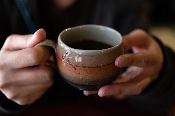 双手捧着咖啡杯